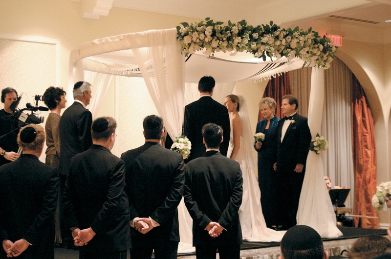 Traditional Jewish Ceremony
Photography: Karen French Photography
Read More:
http://www.insideweddings.com/weddings/romantic-winter-wedding-in-huntington-beach-california/81/ Circular canopy with drapery and flowers at top