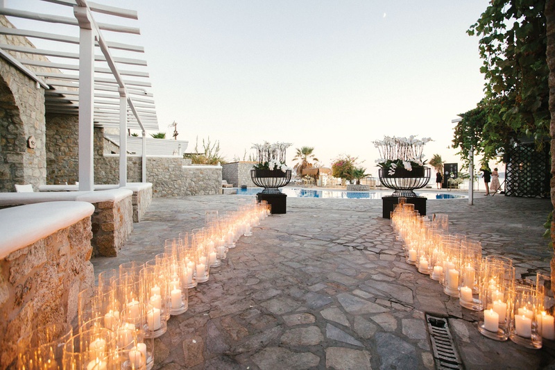Poolside Cocktail Hour with Candles
Photography: Branco Prata
Read More:
http://www.insideweddings.com/weddings/luxe-destination-wedding-with-view-of-aegean-sea-in-mykonos-greece/1372/ weddinng reception entrance pool and pillar candles in glass hurricanes white flowers black modern