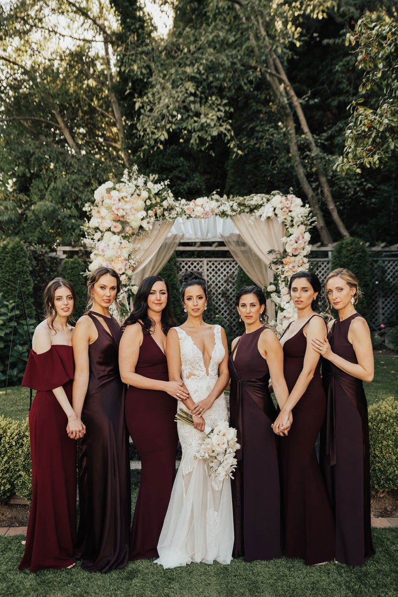 Bridesmaids in Chic Burgundy Gowns
Photography: Sam %26 Sola Lee Photography
Read More:
http://www.insideweddings.com/weddings/modern-outdoor-ceremony-tent-reception-in-seattle-on-puget-sound/1309/ bride in low plunging neckline gown hair up with bridesmaids in mismatch burgundy oxblood dresses