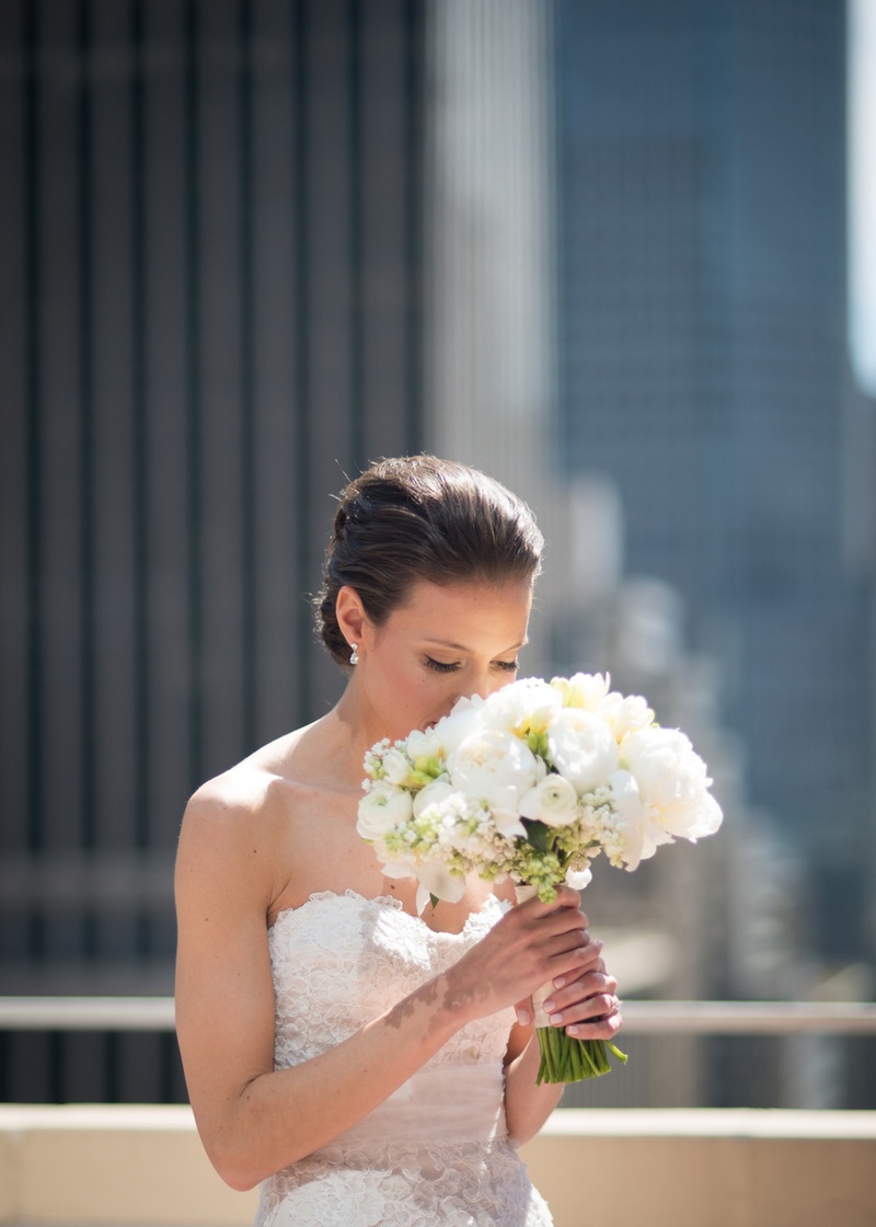 Bride Smells White Bouquet
Photography: Ira Lippke Studios
Read More:
http://www.insideweddings.com/weddings/chic-classic-new-york-city-wedding-with-personal-touches/783/ a bride smelling her bouquet made of white blooms on a rooftop in new york city