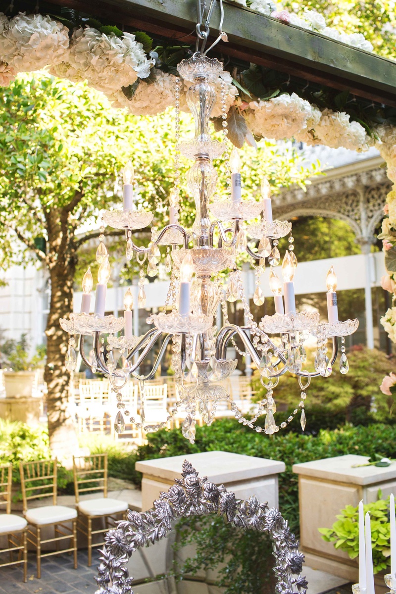 Opulent Chandelier Hanging from Ceremony Arch
Photography: Perez Photography
Read More:
http://www.insideweddings.com/weddings/persian-american-ceremony-with-light-hued-reception-in-dallas/841/ two-tier hanging lighting fixture wooden beam vows outdoor candles silver