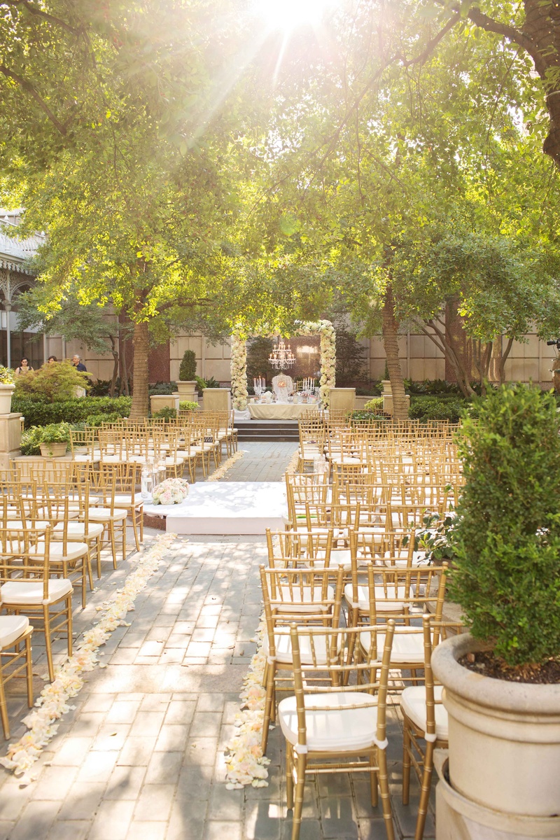 Garden Courtyard Ceremony Space
Photography: Perez Photography
Read More:
http://www.insideweddings.com/weddings/persian-american-ceremony-with-light-hued-reception-in-dallas/841/ gold white cushions rose aisle low hanged branches trees dallas texas flower arch