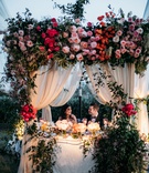 Bride %26 Groom at Lush Sweetheart Table
Photography: Scott Clark Photo
Read More:
http://www.insideweddings.com/weddings/whimsical-outdoor-destination-wedding-at-a-ranch-in-california/1378/ wedding reception sweetheart table under ceremony structure pink flowers greenery drapery