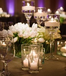 Tulips on Table with Grey Linens
Photography: Next Exit Photography
Read More:
http://www.insideweddings.com/weddings/alfresco-interfaith-ceremony-ballroom-reception-in-santa-monica/963/ Wedding reception purple lighting floating candles candle votives white tulips in clear glass vase