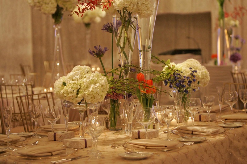 Modern Floral Centerpieces
Photography: Lyn Sims Photographer
Read More:
http://www.insideweddings.com/weddings/glamorous-fall-wedding-with-garden-touches-in-tucson-arizona/258/ Tall glass vases filled with colorful flowers