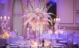 Violet Lighting for Fairy-Tale Reception
Photography: Brian Jarreau Photography
Read More:
http://www.insideweddings.com/weddings/alfresco-ceremony-fairy-tale-wedding-reception-with-lavish-decor/1227/ ashley alexiss wedding reception tall centerpiece white pink flowers silver chairs candles drapes