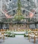In-the-Round Seating for Ceremony
Photography: LuxRox
Read More:
http://www.insideweddings.com/weddings/alfresco-inspired-luxurious-hotel-wedding-in-washington-dc/1312/ wedding ceremony open tent area greenery flower chandelier gold oval back chairs stage greenery