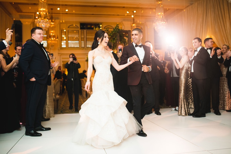 Walking Together Before First Dance
Photography: Mantas Kubilinskas Photography
Read More:
http://www.insideweddings.com/weddings/sophisticated-ceremony-ballroom-reception-in-washington-dc/1296/ bride and groom holding hands and walking on dance floor guests watching chandeliers taking photos