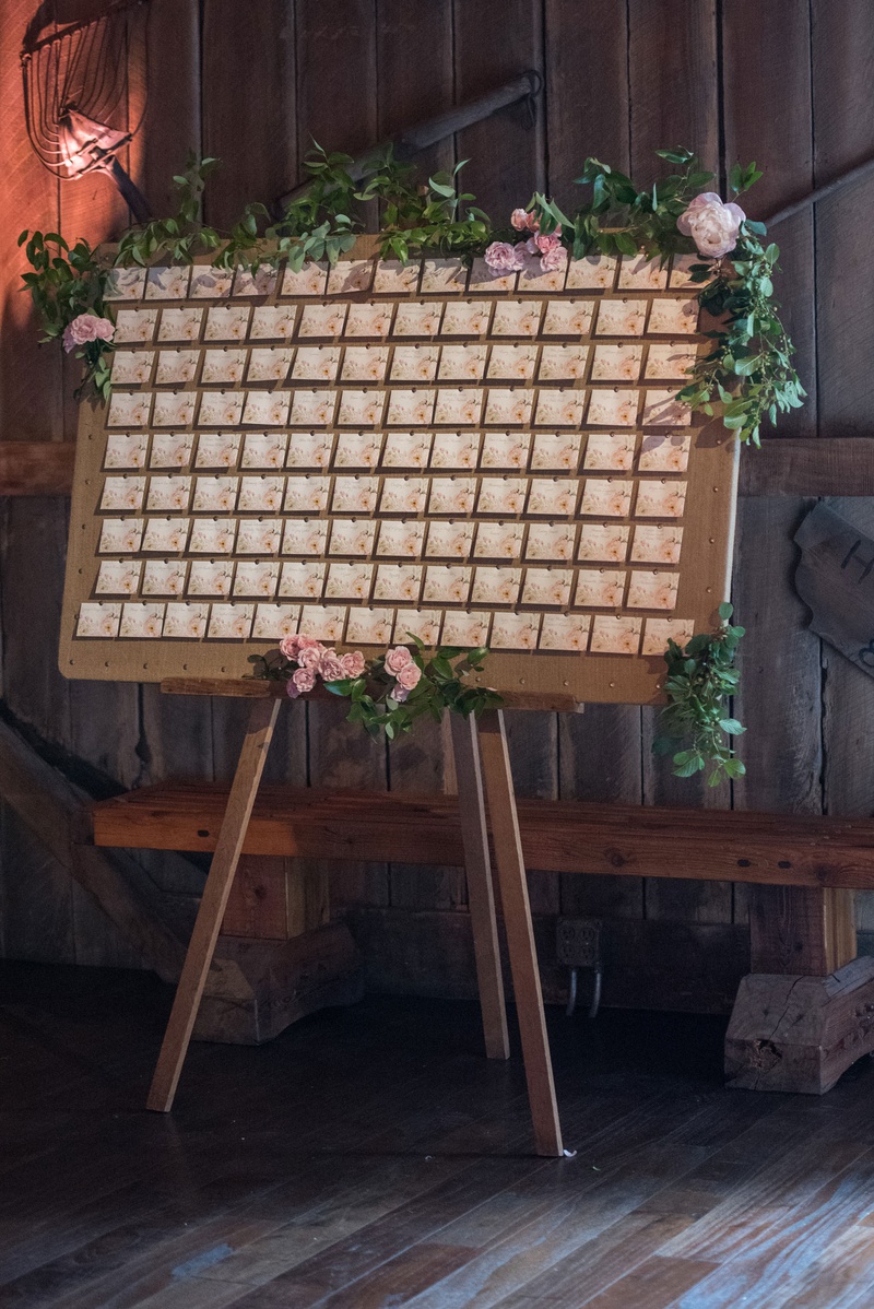 Escort Card Easel
Photography: Little Tree Studios
Read More:
http://www.insideweddings.com/weddings/brian-winters-of-the-new-york-jets-romantic-rustic-chic-wedding/1245/ escort card display on easel with greenery, escort card with pink floral details