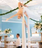 Silk Aerialist at Wedding Reception
Photography: Liz Banfield
Read More:
http://www.insideweddings.com/weddings/sophisticated-playful-southern-jewish-wedding-in-charleston/1076/ Wedding reception special silk aerial performer at reception over bar and server greenery garland