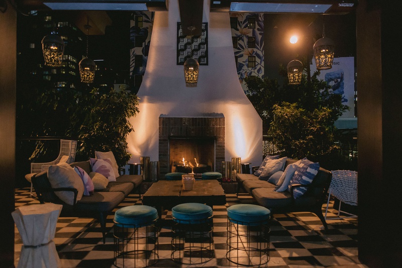 Lounge Area at Outdoor Fireplace
Photography: Maya Myers Photography
Read More:
http://www.insideweddings.com/weddings/candlelit-jewish-ceremony-unique-cozy-outdoor-reception-in-la/1346/ wedding reception lounge area lanterns overhead checkerboard floor fireplace ottoman velvet