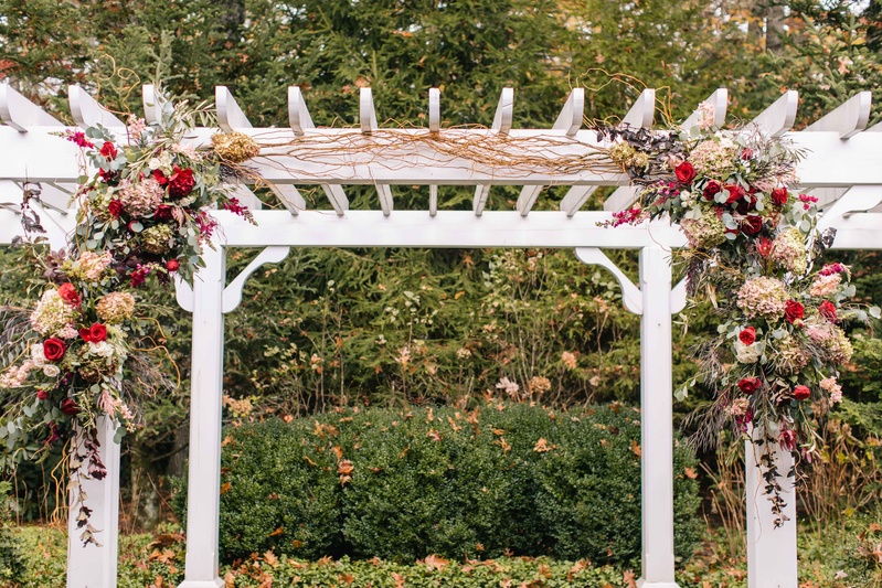 White Arch with Wine-Colored Florals
Photography: Vue Photography
Read More:
http://www.insideweddings.com/weddings/baroque-autumn-wedding-with-deep-wine-tones-in-north-carolina/770/ white arch over altar with wine-colored floral vines in red purple pink and green