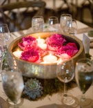 Floating Centerpiece in Bowl
Photography: TimWill Photography
Read More:
http://www.insideweddings.com/weddings/alfresco-wedding-indoor-reception-with-organic-natural-elements/1017/ wooden and gold bowl with floating candles and bright pink peonies