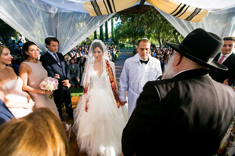 Jewish Couple Marrying Under Chuppah
Photography: Callaway Gable
Read More:
http://www.insideweddings.com/weddings/alfresco-summer-wedding-with-lush-foliage-accents-in-california/805/ a jewish couple wearing traditional garb marrying under chuppah