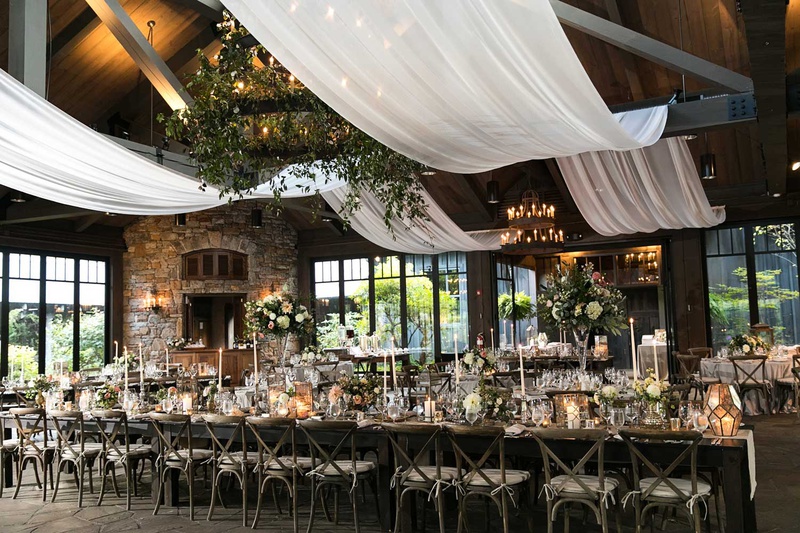 Iron Chandelier with Lights %26 Greenery
Photography: Vue Photography
Read More:
http://www.insideweddings.com/weddings/destination-rustic-fall-wedding-at-a-farm-in-north-carolina/1202/ wedding reception white drapery through rafters beams iron chandelier with greenery long table