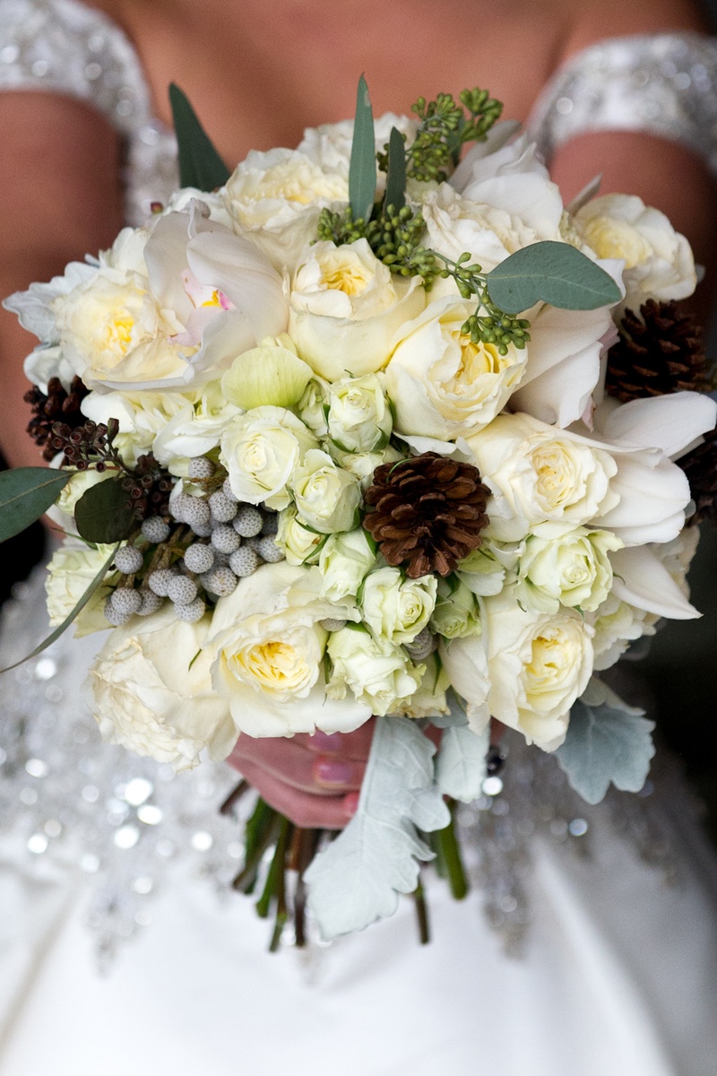 Wintry Bridal Bouquet
Photography: Handeland Tesoro Photography
Read More:
http://www.insideweddings.com/weddings/snowy-outdoor-winter-ceremony-cozy-lodge-reception/522/ Bride carrying pinecones, leaves, and white flowers