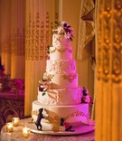 Gold Filigree Wedding Cake Details
Photography: Ira Lippke Studios
Read More:
http://www.insideweddings.com/weddings/opulent-destination-wedding-at-a-luxury-hotel-in-new-york-city/1004/ Wedding cake with gold filigree details sugar flowers and dog puppy biting bottom layer of cake
