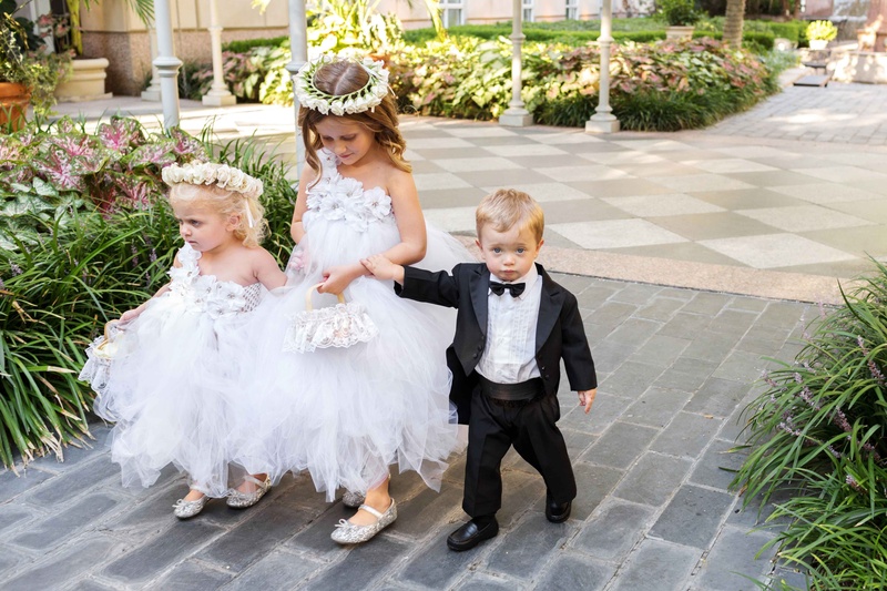 Flower Girls in White, Little Boy in Tuxedo
Photography: Perez Photography
Read More:
http://www.insideweddings.com/weddings/persian-american-ceremony-with-light-hued-reception-in-dallas/841/ toddler girls boy tulle tutu skirts purses tux bow tie alfresco ceremony