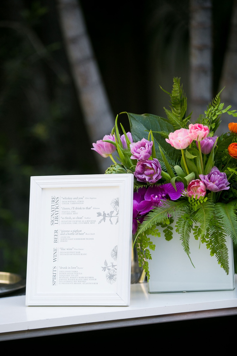Song-Themed Cocktails %26 Libations
Photography: Callaway Gable
Read More:
http://www.insideweddings.com/weddings/modern-in-the-round-ceremony-whimsical-garden-inspired-reception/1155/ Wedding cocktail hour menu in white frame song name cocktails beer and wines spirits flowers
