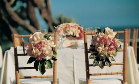 Oceanfront Sweetheart Table
Photography: Miki and Sonja Photography
Read More:
http://www.insideweddings.com/weddings/shabby-chic-garden-wedding-in-malibu-california/112/ Table with floral centerpiece and flowers on chair