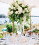 Roses, Hydrangeas %26 Eucalyptus Arrangement
Photography: Nicole Barr Photography
Read More:
http://www.insideweddings.com/weddings/ceremony-overlooking-the-bay-tented-reception-at-beach-house/1295/ wedding reception centerpiece with ivory roses, hydrangeas, and eucalyptus leaves