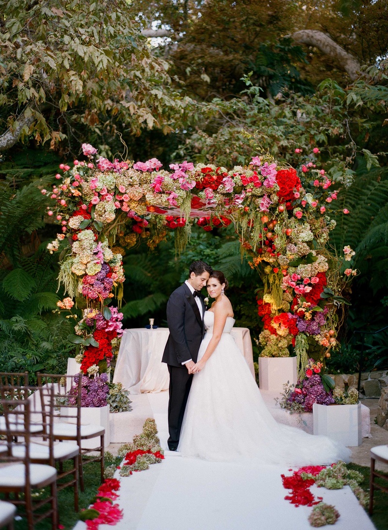 Bride %26 Groom at Hotel Bel-Air Chuppah
Photography: Mi Belle Photographers
Read More:
http://www.insideweddings.com/weddings/colorful-outdoor-wedding-with-supper-club-theme-in-los-angeles-ca/741/ Bride and groom hold hands under colorful Jewish wedding chuppah at Hotel Bel-Air Swan Lake