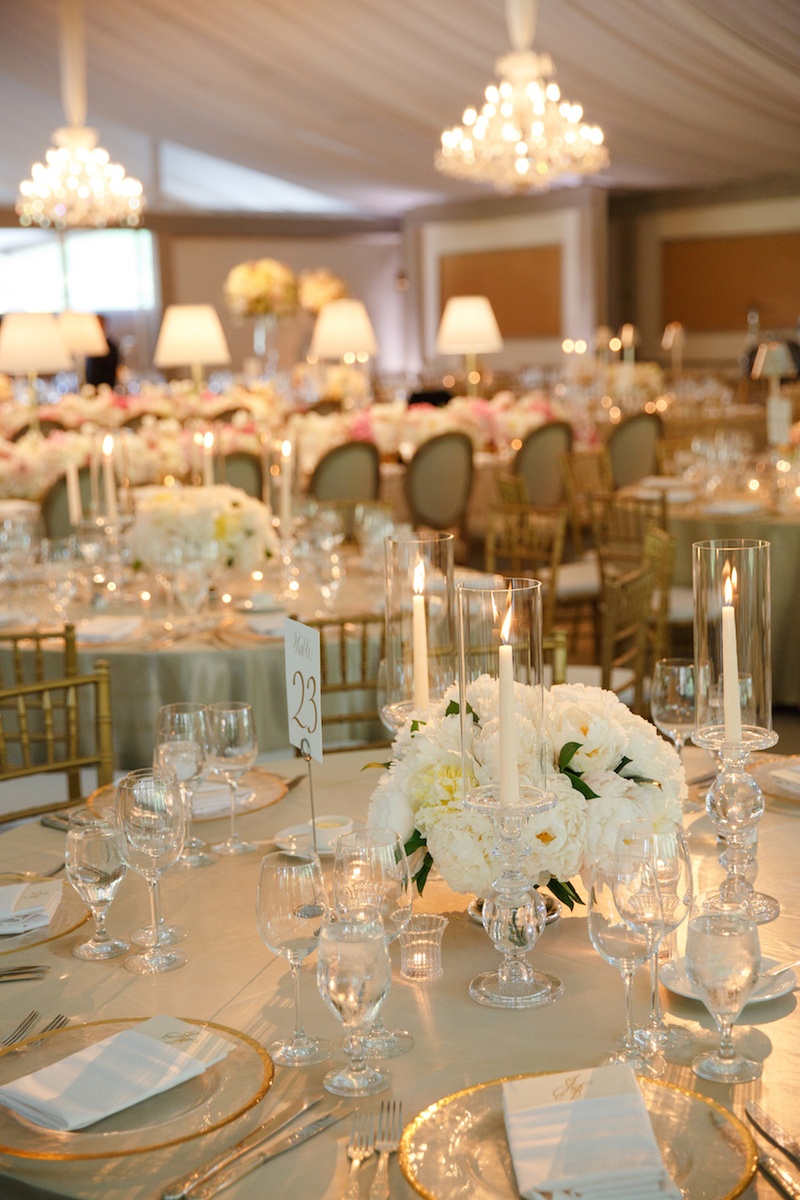 Low White Centerpiece
Photography: Karlisch Studio
Read More:
http://www.insideweddings.com/weddings/southern-chic-wedding-in-oklahoma-with-performance-by-boyz-ii-men/697/ Wedding reception table with golden tablecloth and centerpiece of white peonies, taper candles