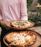 Wood-Fired Pizzas at Cocktail Hour
Photography: Cacá Santoro for Max %26 Friends
Read More:
http://www.insideweddings.com/weddings/intimate-outdoor-ceremony-alfresco-dinner-party-style-reception/1367/ server at outdoor wedding reception wood fired pizzas neopolitan style red sauce gourmet pizzas