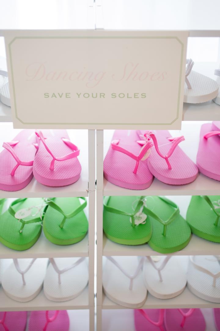 Reception Dancing Shoes
Photography: Carrie Rodman Photography
Read More:
http://www.insideweddings.com/weddings/new-england-summer-wedding-by-the-seashore/429/ Pink, green, and white flip flops in white cubby