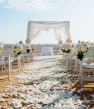 All-White Beach Wedding
Photography: Yvette Roman Photography
Read More:
http://www.insideweddings.com/weddings/all-white-wedding-at-a-beach-club-in-santa-monica-california/706/ Beachside wedding ceremony with white petals on aisle, bundles of white hydrangeas, roses on chairs