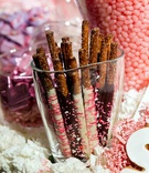 Chocolate Pretzel Sticks
Photography: Bob %26 Dawn Davis Photography
Read More:
http://www.insideweddings.com/weddings/spring-wedding-in-chicago-with-purple-lighting/381/ Glass vase filled with chocolate-covered pretzels