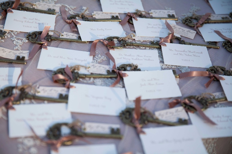Escort Cards with Keys and Ribbon
Photography: Michael Bambino %26 Co.
Read More:
http://www.insideweddings.com/weddings/whimsical-open-air-secret-garden-wedding-with-soft-spring-hues/777/ white escort cards with golden keys adorned with soft pink ribbons