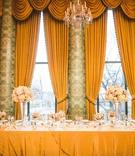 Head Table in Front of Drapes at Reception
Photography: Peter Gubernat Photography
Read More:
http://www.insideweddings.com/weddings/spring-real-wedding-with-ivory-blush-gold-details-in-chicago/1184/ wedding reception head table tall drapes valances hotel wedding ballroom high low centerpieces