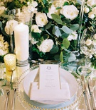 Gold-Border Menu Card on Mirror Table
Photography: Adam Barnes
Read More:
http://www.insideweddings.com/weddings/elegant-real-wedding-at-a-charming-resort-in-the-countryside/1141/ Wedding reception mirror table top with greenery and white flower runner candles gold candle votive