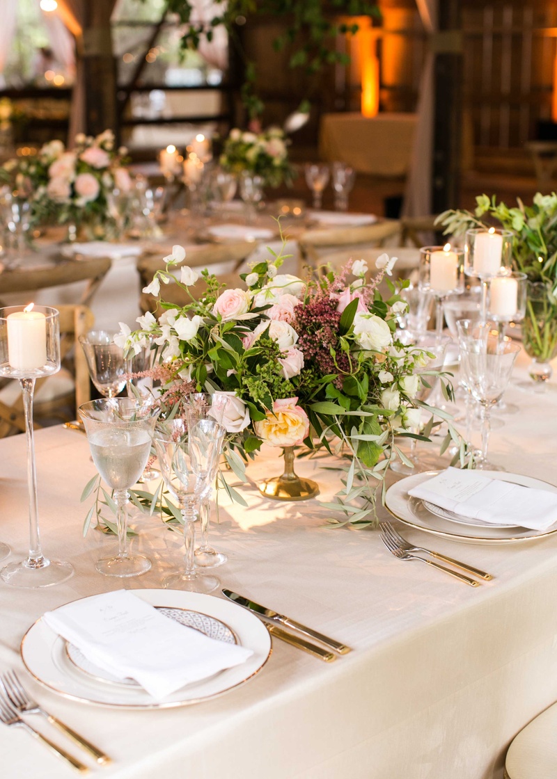 Low Centerpiece in Gold Footed Vessel
Photography: Samuel Lippke Studios
Read More:
http://www.insideweddings.com/weddings/a-rustic-camp-themed-outdoor-wedding/908/ Long reception table with crystal candleholder low centerpiece gold vessel with green leaves pink