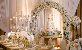 Floral Arch Over Tall Cake
Photography: Lin %26 Jirsa Photography
Read More:
http://www.insideweddings.com/weddings/gorgeous-outdoor-ceremony-ballroom-reception-in-rancho-mirage/996/ Wedding cake sugar flowers under flower arch long table candelabra gold chairs white flowers