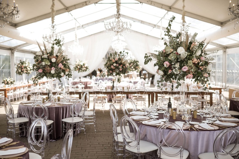 Vintage-Boho Tented Reception
Photography: Belle Ombre Photography
Read More:
http://www.insideweddings.com/weddings/vintage-bohemian-inspired-wedding-on-historic-bridge-in-cleveland/1373/ wedding reception tent lavender purple table acrylic chairs greenery pink flowers chandeliers