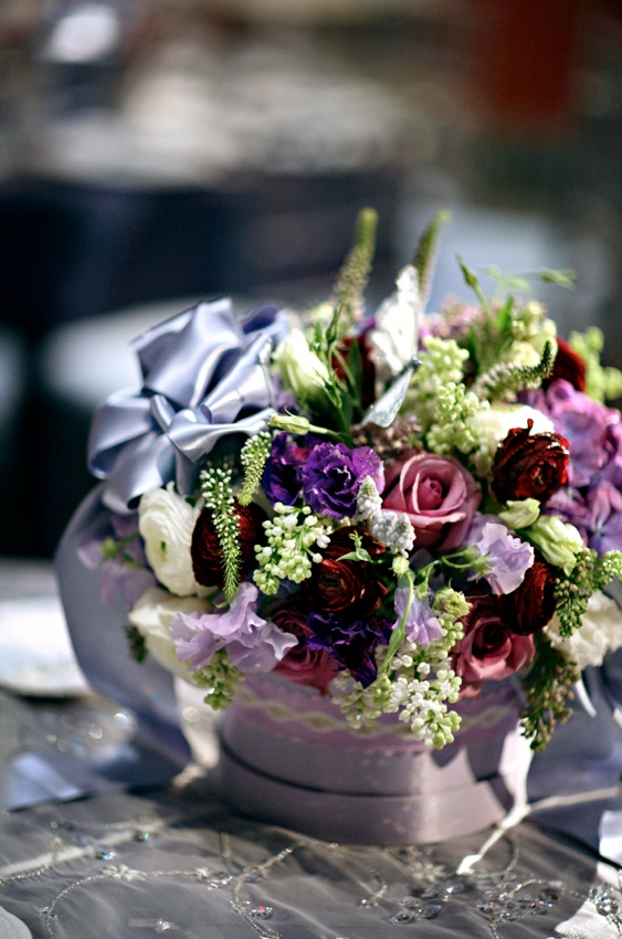 Floral Arrangement
Photography: Marie Labbancz Photography
Read More:
http://www.insideweddings.com/weddings/elegant-spring-wedding-at-the-pennsylvania-academy-of-the-fine-arts/176/ Colorful flowers with a lavender bow in a ribbon wrapped container