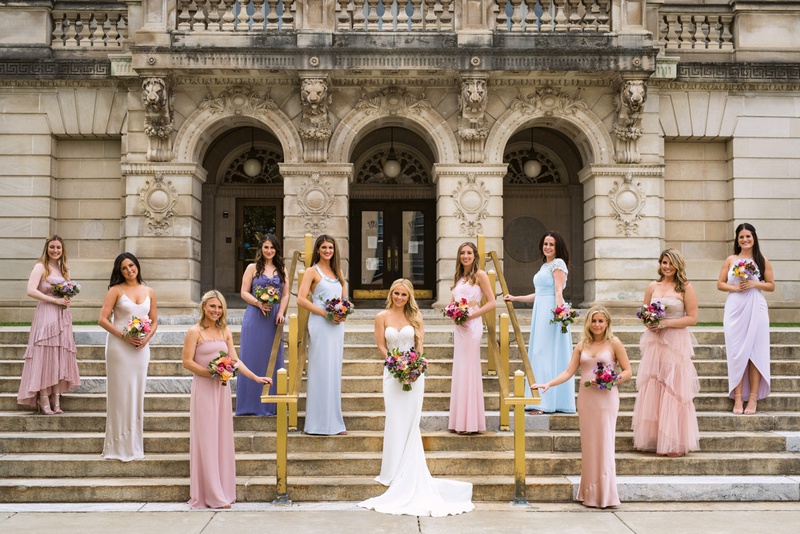 Bridesmaids in Mismatched Gowns on Steps
Photography: Kent Drake Photography
Read More:
http://www.insideweddings.com/weddings/bright-and-colorful-wedding-palette-with-ceremony-overlooking-lake/1315/ bridesmaids in pink, champaign, blue, and periwinkle standing on steps