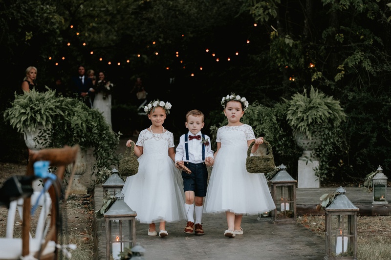 Two Flower Girls %26 Cute Ring Bearer
Photography: Grant Daniels Photography
Read More:
http://www.insideweddings.com/weddings/outdoor-ceremony-tented-reception-with-cozy-fall-color-palette/1183/ two cute flower girls white dresses moss baskets ring bearer in suspenders high socks bow tie