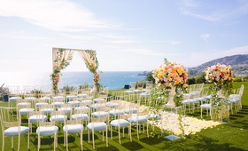 Alfresco Ocean-View Wedding in Laguna
Photography: Ashley Paige Photography
Read More:
http://www.insideweddings.com/weddings/romantic-ocean-view-ceremony-charming-reception-in-california/1337/ wedding ceremony yellow flower petal aisle arch ocean view ceremony chameleon chair collection chair