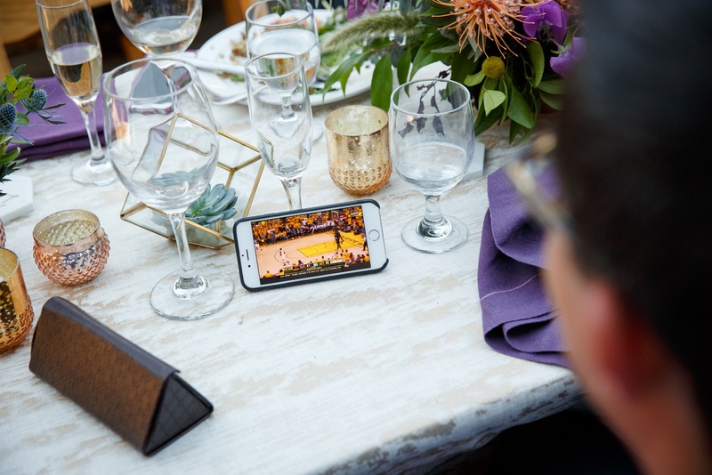 Guest Watches Basketball Game on Phone
Photography: Karlisch Photography
Read More:
http://www.insideweddings.com/weddings/modern-rustic-wedding-full-of-flowers-and-geometric-details/906/ wedding guest watches nba game 7 finals on phone during reception