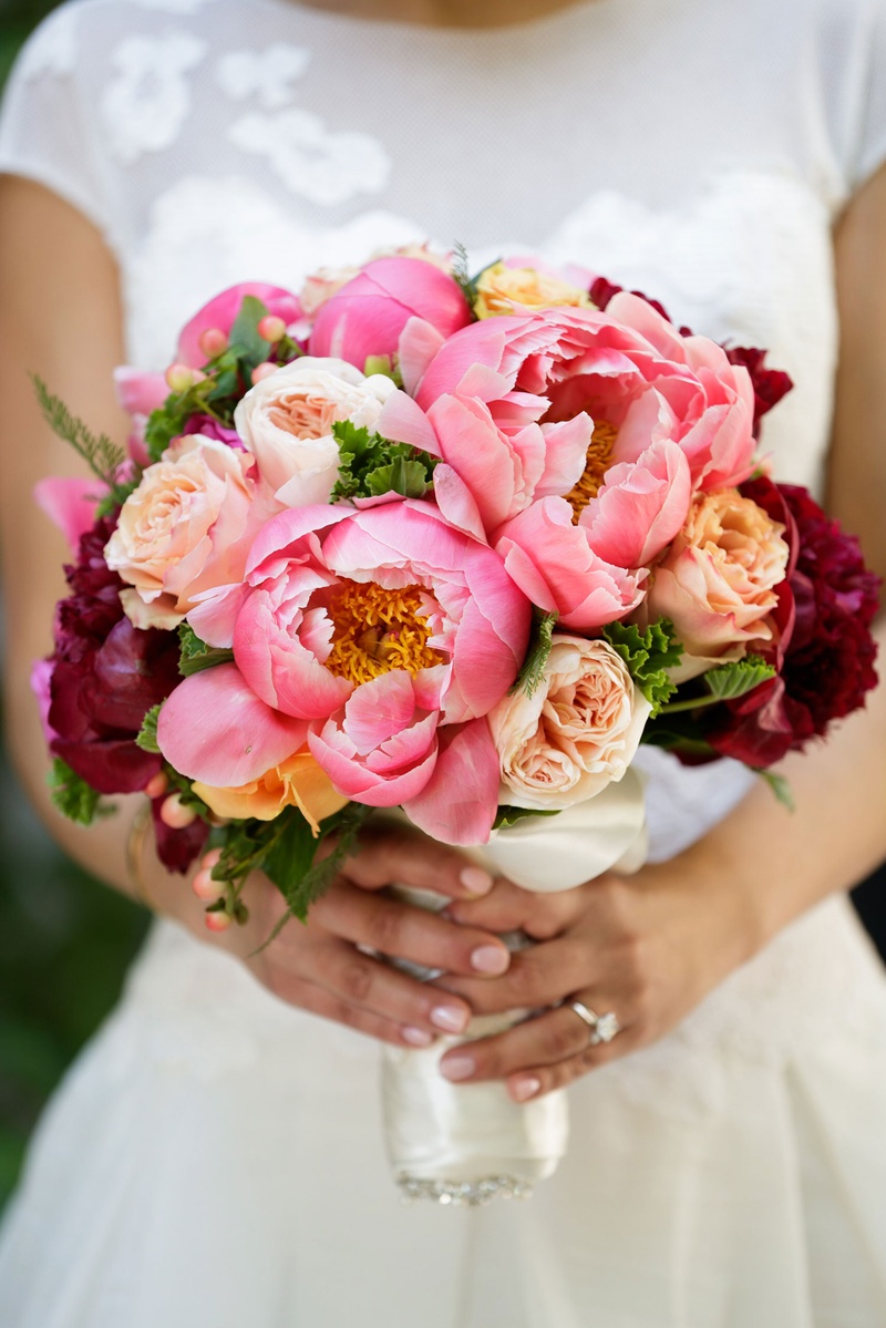 Hot Pink Peony Bouquet
Photography: Bob %26 Dawn Davis Photography
Read More:
http://www.insideweddings.com/weddings/church-ceremony-colorful-tented-reception-at-a-private-residence/1025/ Bride holding bouquet of hot pink peony garden rose and red burgundy blooms