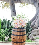 Wood Barrel with Rose Arrangement
Photography: Love and Water Photography
Read More:
http://www.insideweddings.com/weddings/destination-hawaiian-wedding-with-travel-vintage-theme-in-maui/772/ barrels displaying akimo roses, pink roses, peach roses, dusty miller