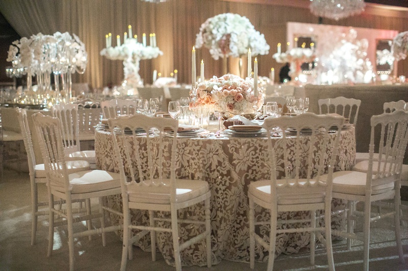 White Chairs and Lace Linens
Photography: Jessica Claire Photography
Read More:
http://www.insideweddings.com/weddings/traditional-armenian-ceremony-luxurious-ballroom-reception/1006/ lace linens with white chairs, white and neutral wedding reception