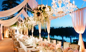Waterfront Reception
Photography: KT Merry Photography
Read More:
http://www.insideweddings.com/weddings/a-gorgeous-and-elegant-outdoor-florida-wedding/536/ Waterfront wedding reception with sheer pink panels, chandeliers, and floral arrangements