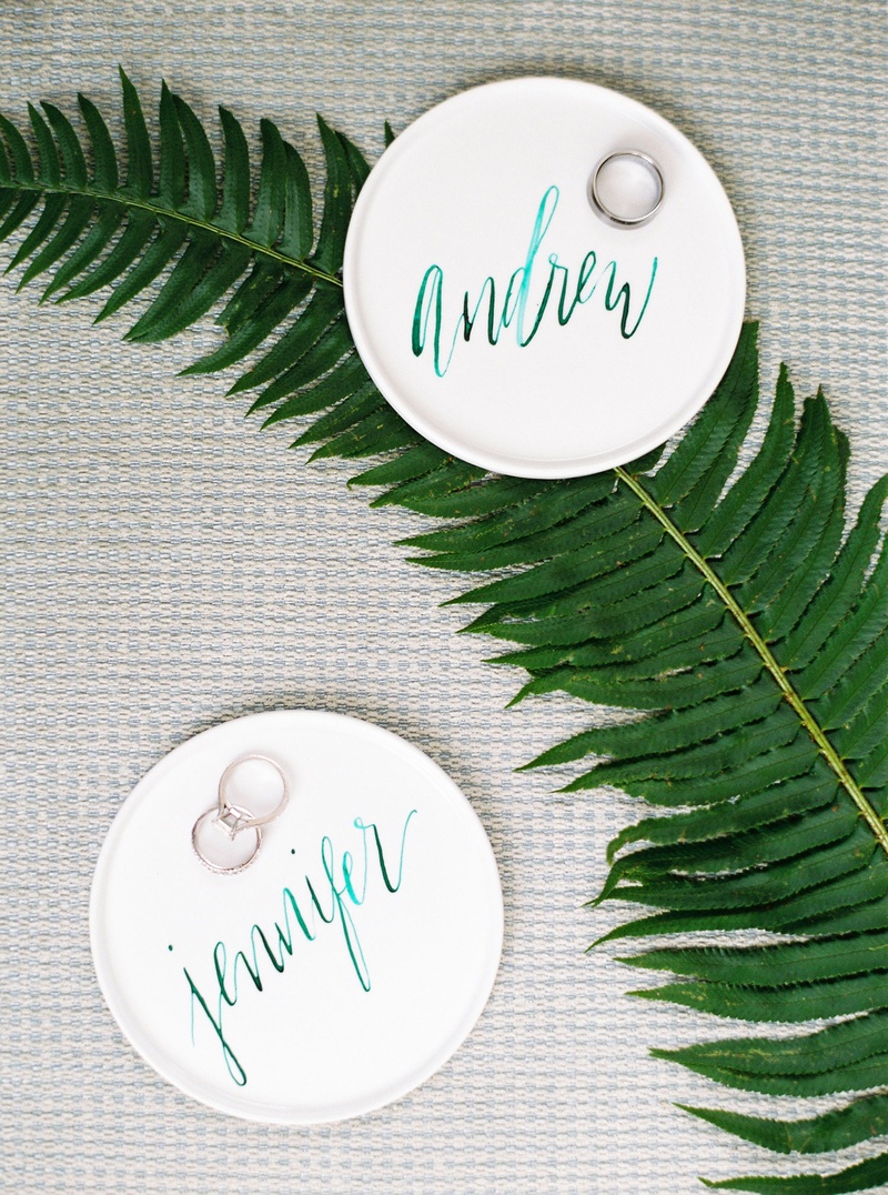 Calligraphy Ring Tray with Bands
Photography: Branco Prata
Read More:
http://www.insideweddings.com/weddings/chic-destination-wedding-with-california-style-in-washington-dc/1042/ Wedding rings on personalized teal modern calligraphy on ring holder trays white on fern leaf
