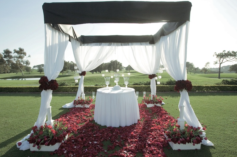 Golf Course Ceremony
Photography: Ventana Photography
Read More:
http://www.insideweddings.com/weddings/black-and-red-wedding-on-golf-course-at-the-lodge-at-torrey-pines/122/ Black and white ceremony structure with red rose petals on golf course