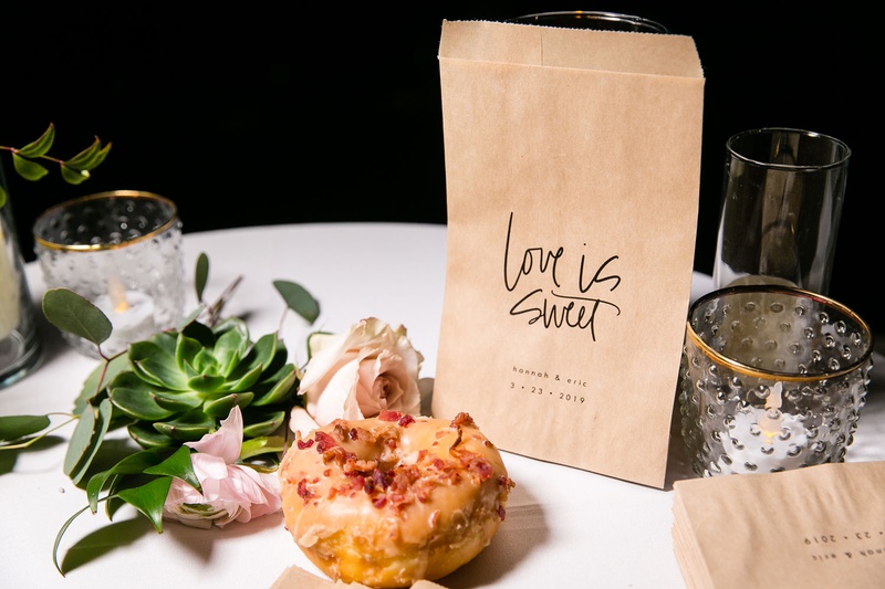 "Love Is Sweet" Take-Home Bag
Photography: Aevitas Weddings
Read More:
http://www.insideweddings.com/weddings/rooftop-ceremony-ballroom-reception-with-english-garden-theme/1286/ donut maple and bacon with kraft paper love is sweet to go take home bag succulent pink flower favor