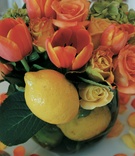 Tulip and Lemon Centerpiece
Photography: David Michael Photography
Read More:
http://www.insideweddings.com/weddings/a-citrus-toned-beach-wedding-in-santa-monica-california/67/ glass bowl filled with orange tulips and roses and lemons